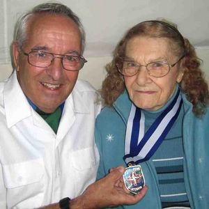 Gerry Bryan presents a medallion to Galt Legion member Joan Laidlaw